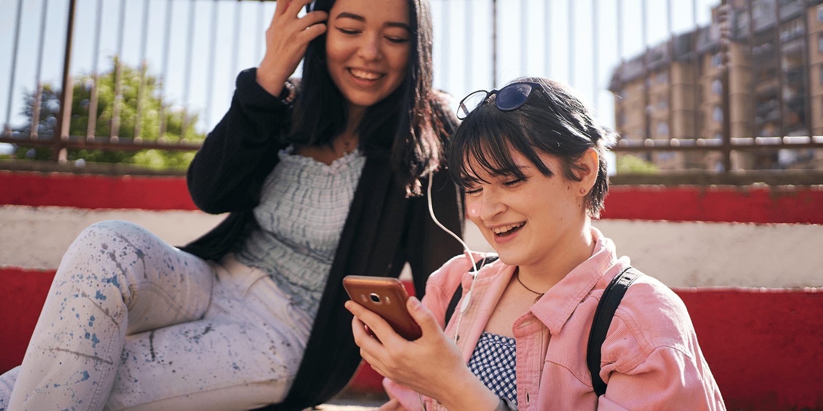 Two female students looking at a cell phone