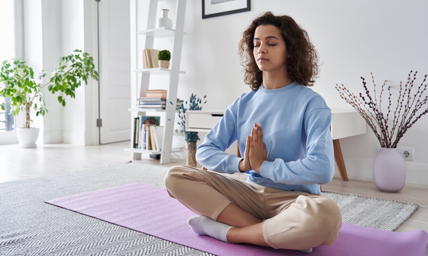 Illustration of a woman in a yoga pose meditating