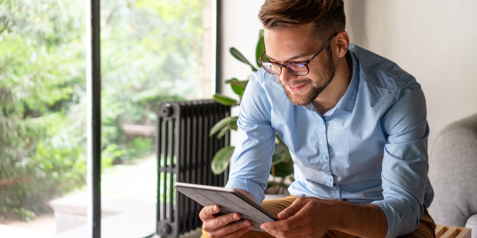 Man smiling looking at tablet