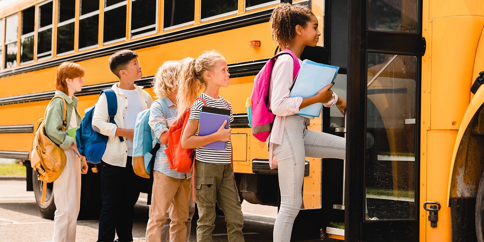 School children getting on a school bus.
