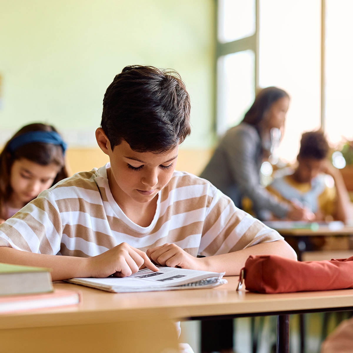 Young boy studing in the classroom.