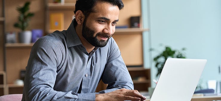 Adult male working at a laptop computer. 