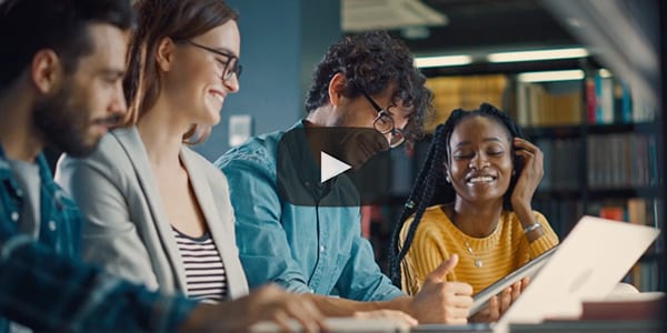 Four people looking at tablet