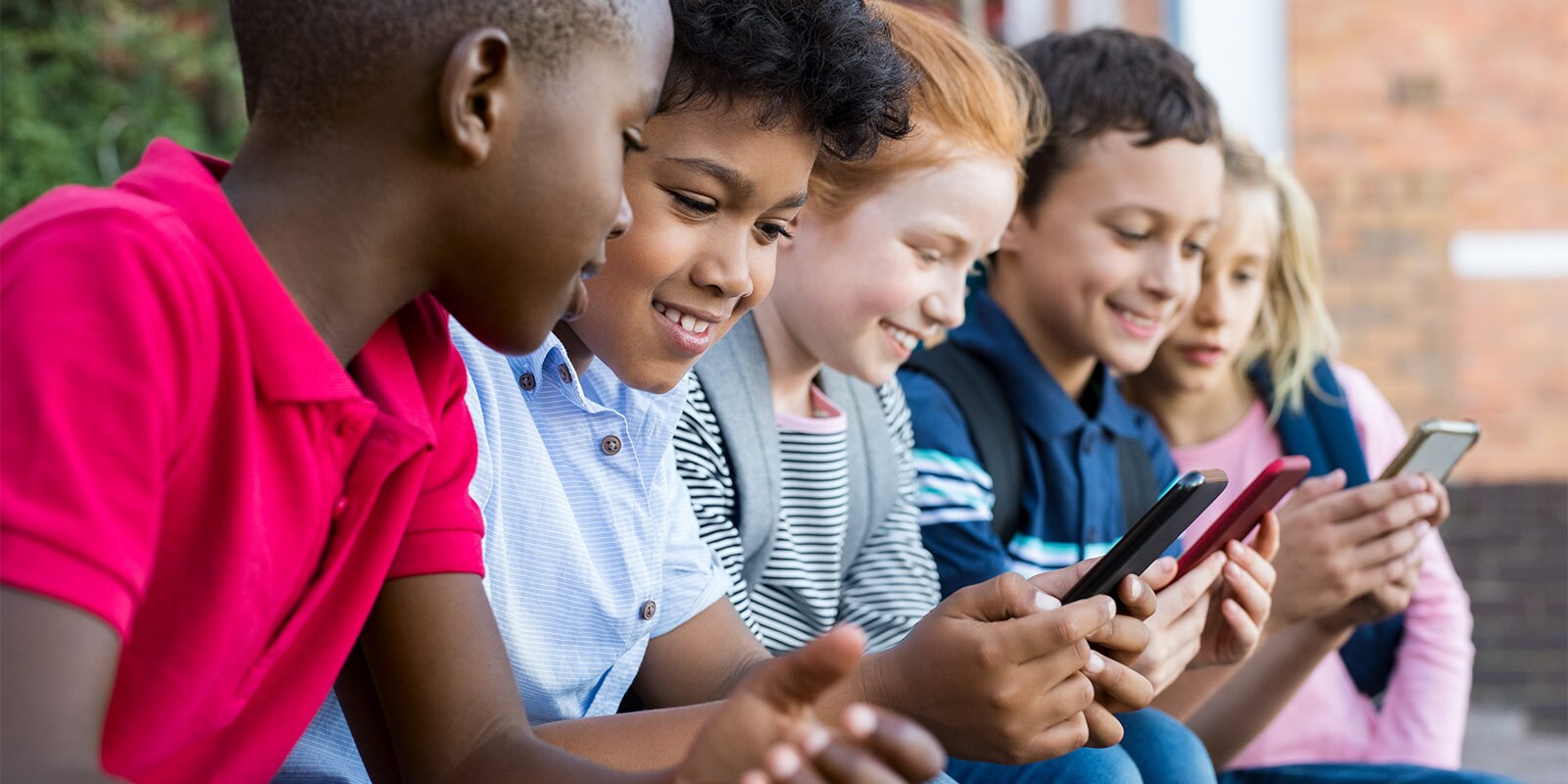 A diverse group of young students using cell phones